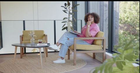 Woman Relaxing in Minimalist Workspace with Laptop