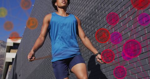 African American Man Jumping Rope with Digital Media Icons Overlay