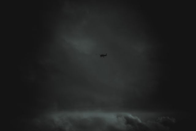 Small Airplane Flying Through Dark Stormy Sky - Download Free Stock Photos Pikwizard.com