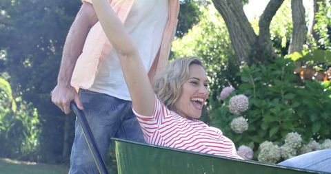 Couple Enjoying Playful Moment in Sunny Garden