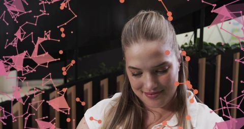 Innovative Woman in Modern Workspace Viewed Through Technological Overlay