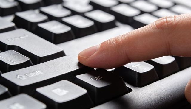 Closeup Fingertip Pressing Ctrl Key on Black Keyboard for Computer Shortcut Concept