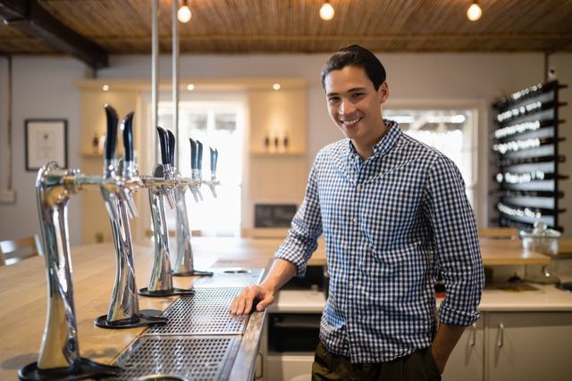Portrait of smiling man at counter in restaurant