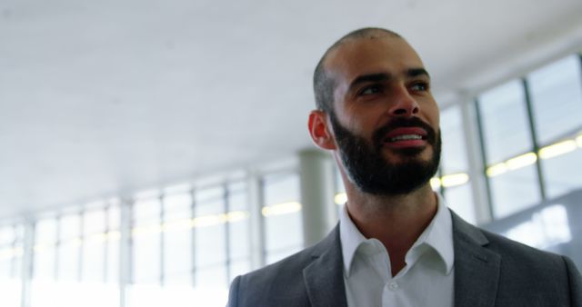 Confident Businessman Smiling in Bright Modern Office - Download Free Stock Images Pikwizard.com