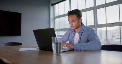 Focused Businessman Working on Laptop in Minimalist Office - Download Free Stock Images Pikwizard.com