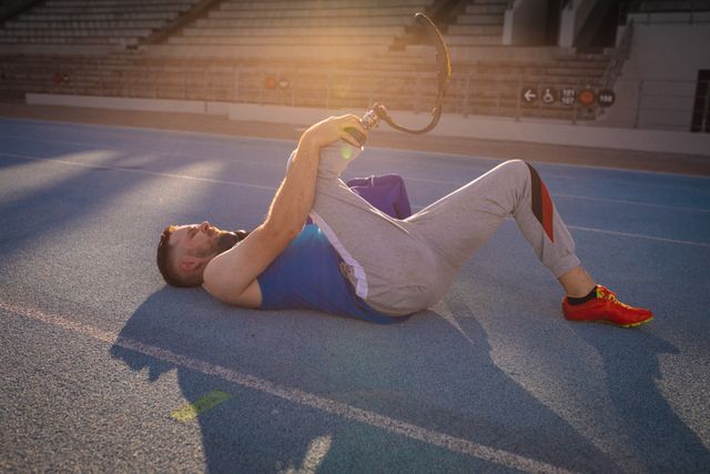 Disabled Male Athlete Stretching on Track at Sunset - Download Free Stock Photos Pikwizard.com