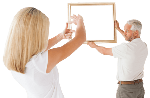 couple collaboratively hanging transparent picture frame - Download Free Stock Videos Pikwizard.com