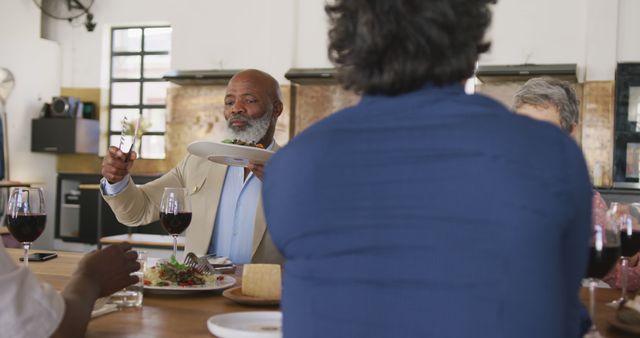 Senior Man Enjoying Meal with Friends in Cozy Kitchen Setting - Download Free Stock Images Pikwizard.com