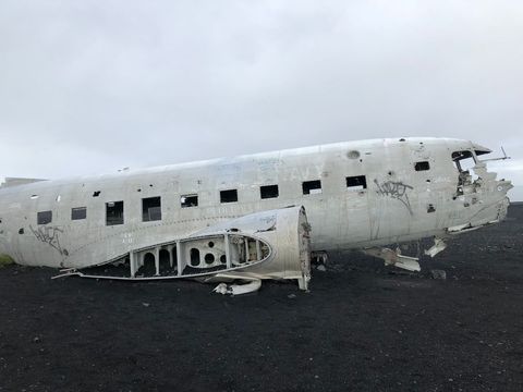 Abandoned plane crash  wreck on black sand beach