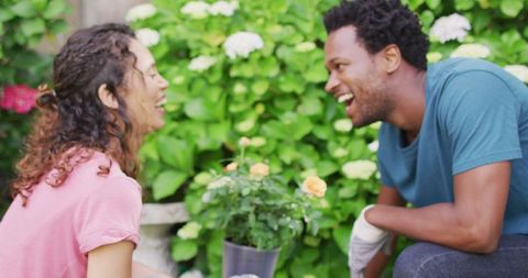 Joyful Couple Gardening Together in Vibrant Garden