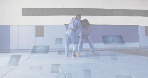 Male Judo Grappling Drill on Blue Mats with Gi Uniforms and Padded Dojo Walls Sparring