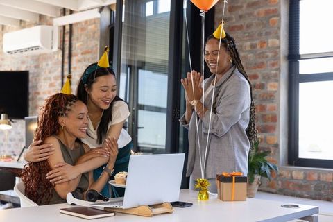 Colleagues Celebrating Birthday in Office With Party Hats