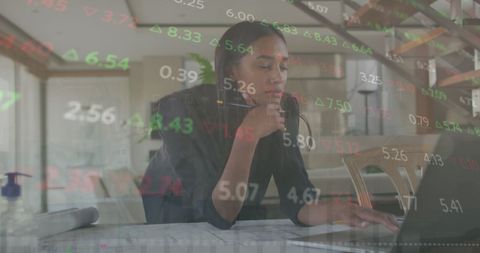Businesswoman Analyzing Financial Data on Laptop Screens