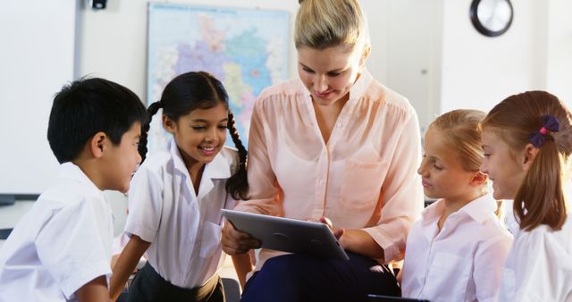 Teacher Engaging with Students Using Digital Tablet in Classroom - Download Free Stock Images Pikwizard.com