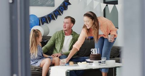 Joyful Family Celebration with Cake and Happy Moments