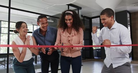 Diverse Team Celebrating New Office Opening with Ribbon Cutting