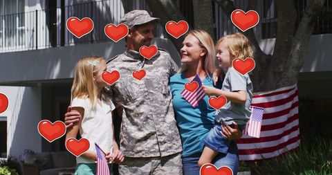 Returning Soldier Embracing Family with American Flags