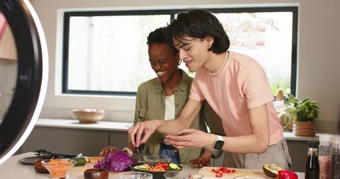 Diverse Couple Preparing Healthy Bowl in Bright Kitchen Under Ring Light for Social Media