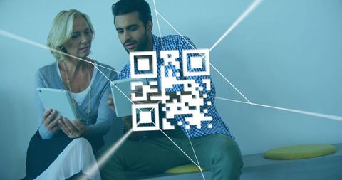 Coworkers interacting with digital qr code technology in modern office