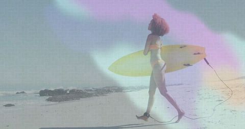 Woman Strolling with Yellow Surfboard on Sunny Beach