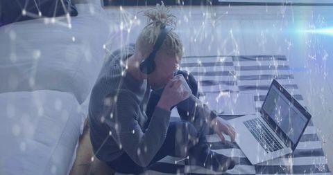 Tech Entrepreneur Working Remotely with Laptop in Cozy Bedroom