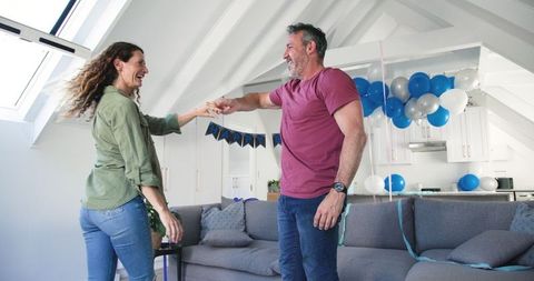 Couple Dancing Joyfully at Home Birthday Celebration