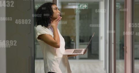 Contemplative Businesswoman Analyzing Financial Data on Laptop