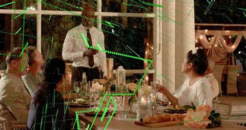 Evening alfresco dinner with waiter giving toast and green digital network overlay on patio