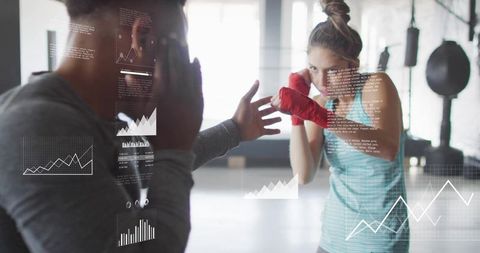 Coach Holding Focus Pads While Female Athlete Punching with Performance Data Overlay
