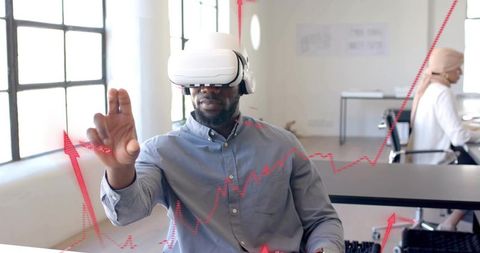 Man Engaging with Augmented Analytics Using VR Headset in Modern Office