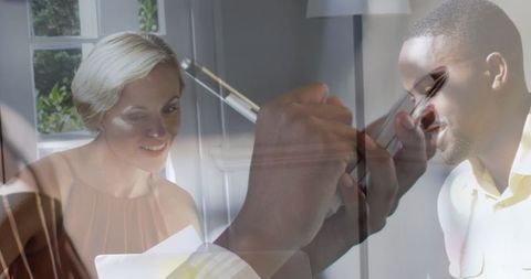 Waiter's digital notes in restaurant setting with diverse couple