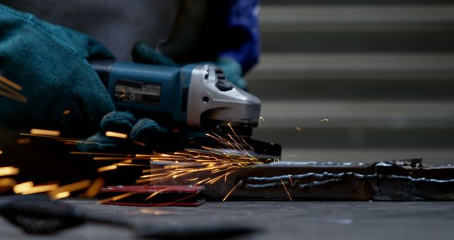 Worker Uses Angle Grinder with Stream of Sparks at Construction Site - Download Free Stock Images Pikwizard.com