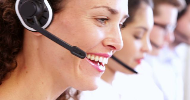 Close-Up of Smiling Customer Service Representatives with Headsets - Download Free Stock Images Pikwizard.com