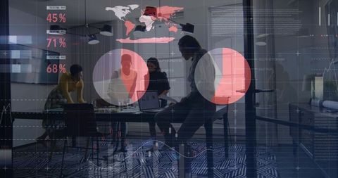 Businesswomen analyzing digital data on laptop with pie charts in glass meeting room