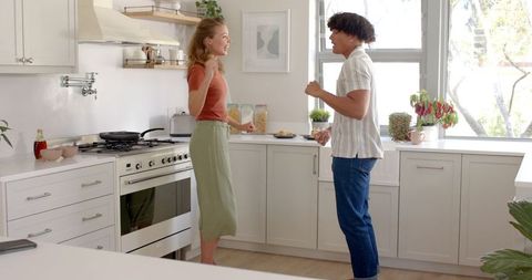 Couple Engaging in Conversation in Bright Modern Kitchen