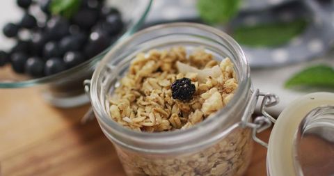 Healthy Breakfast: Oat Granola in Jar with Fresh Berries
