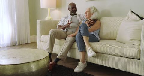 Senior Couple Conversing Comfortably on Modern Sofa