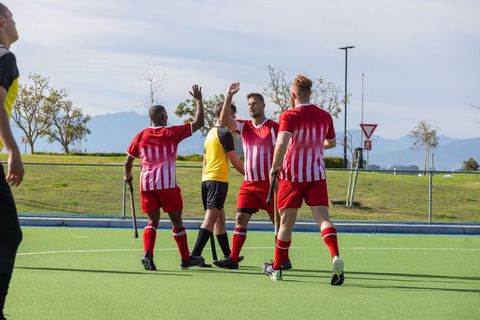 Field hockey teammates celebrating victory together outdoors