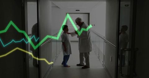 Senior pediatrician examining child in hospital corridor with neon health analytics overlay