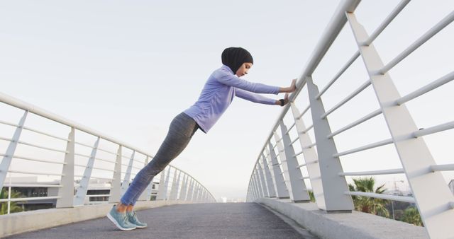 Fit Woman in Hijab Doing Pushups on Bridge at Sunrise - Download Free Stock Images Pikwizard.com