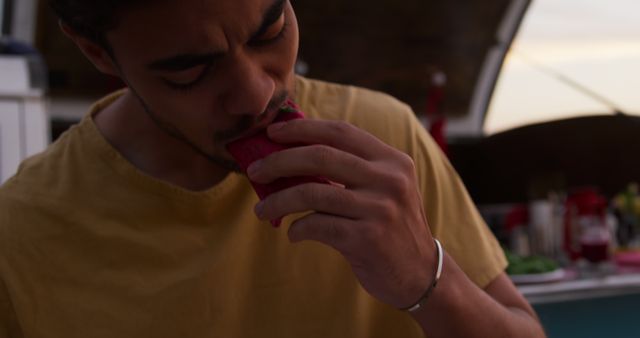 Man Eating Fruit in Outdoor Setting, Relaxing Evening Atmosphere - Download Free Stock Images Pikwizard.com