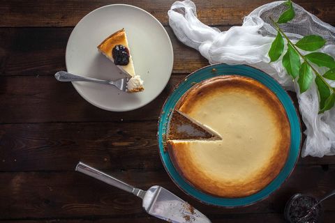 Cheesecake with Slice of Blueberry Topping on Rustic Table