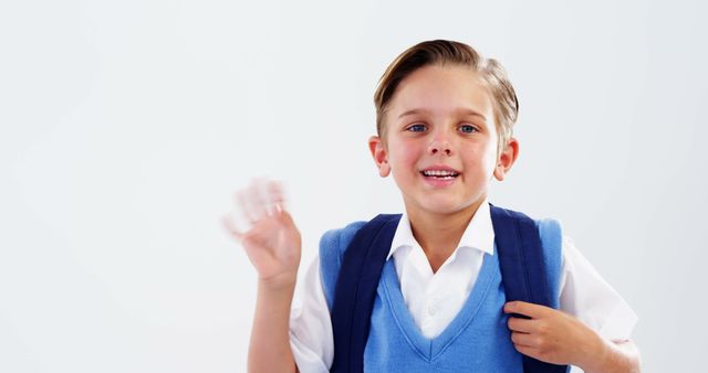 Young Boy in School Uniform Waving with Backpack - Download Free Stock Images Pikwizard.com