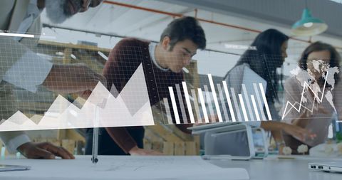Business team analyzing graphs and charts in modern office