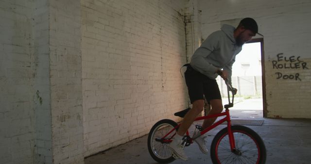 Young Man Performing Bicycle Tricks in Abandoned Building - Download Free Stock Images Pikwizard.com