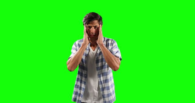 Stressed Young Man Holding Head with Hands on Green Screen Background - Download Free Stock Images Pikwizard.com