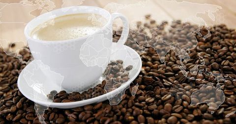 Global Coffee Trade Concept with Frothy Cup on Roasted Beans and World Map Overlay