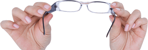 Hands holding eyeglasses isolated on transparent surface
