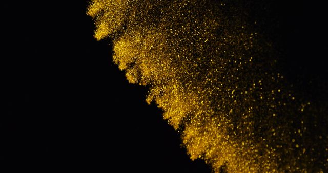 Golden glitter particles sparkling against a black background creates a luxurious and festive feel. Ideal for backgrounds, celebration themes, posters, invitations, website banners, and promotional materials highlighting luxury and class.