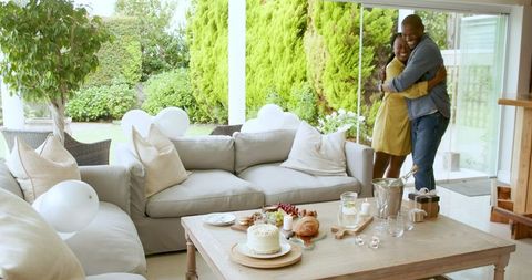 Couple embracing joyfully with celebration table decor
